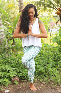 women in leggings with eagle pose in nature
